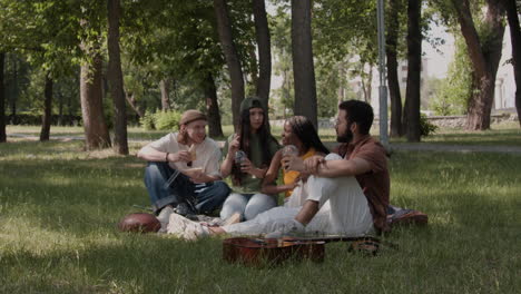 group of friends having a picnic in a park
