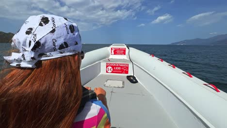 first person view of redhead child on speed boat sailing over north corsica sea water for tour