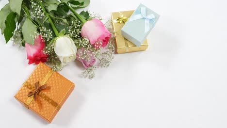 golden gift boxes and bouquet of roses 4k