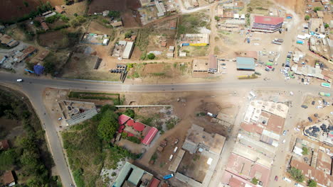 aerial of a busy road running through a small town in kenya
