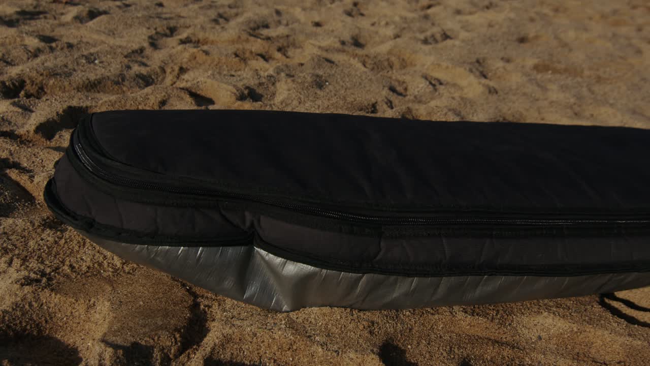 Surfer man walking to the beach at sunset preparing for surfing training and search for waves in Barcelona, spain, water, ocean exercise in sea with board, athletic male holiday or travel in vacation