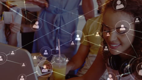 animación de la red de iconos de perfil sobre el retrato de una mujer afroamericana usando una computadora portátil en la oficina