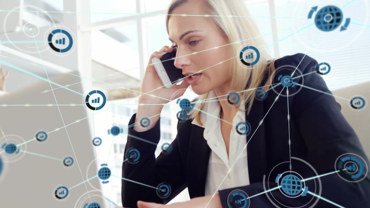 Animation of connected icons over caucasian businesswoman working on laptop and talking on cellphone