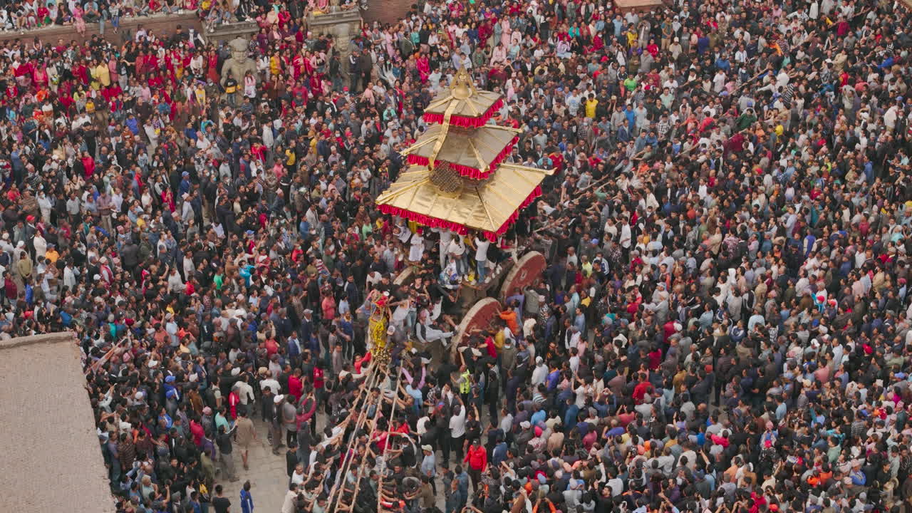 Huge crowd of Nepali people to witness Newari festival at Bhaktapur Durbar Square pulling chariot with unity, people enjoy and celebrate Bisket Jatra Drone shot reveling prosperity of culture in Nepal