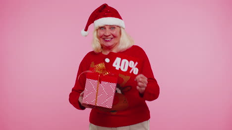 Grandmother-in-Christmas-sweater-showing-gift-box-and-40-Percent-discount-inscriptions-banner-text