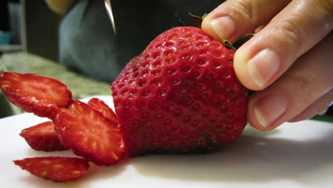 close-up of the slicing of a strawberry