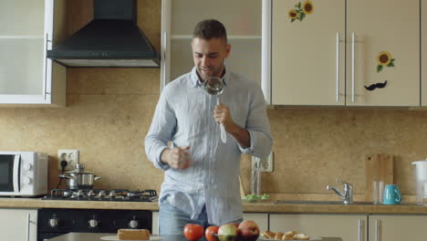 man singing while cooking in the kitchen