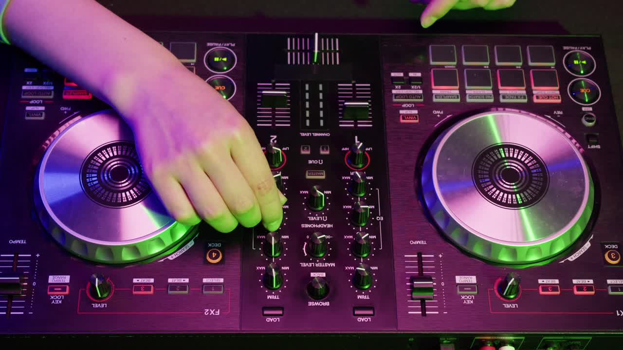 DJ with headphones and sunglasses playing music on festival in night club. Techno musician performing at nightclub for concert crowd of people, city bar.