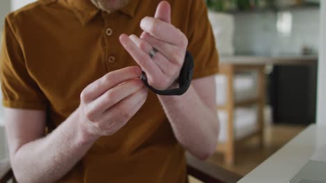 Albino-african-american-man-with-dreadlocks-using-smartwatch