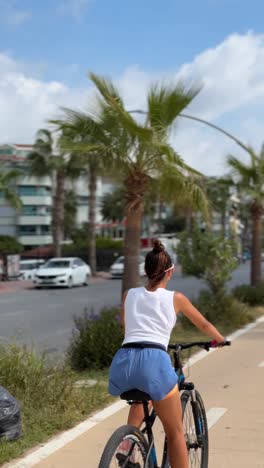 woman cycling on a coastal bike path