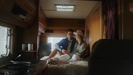 couple relaxing in a cozy camper van