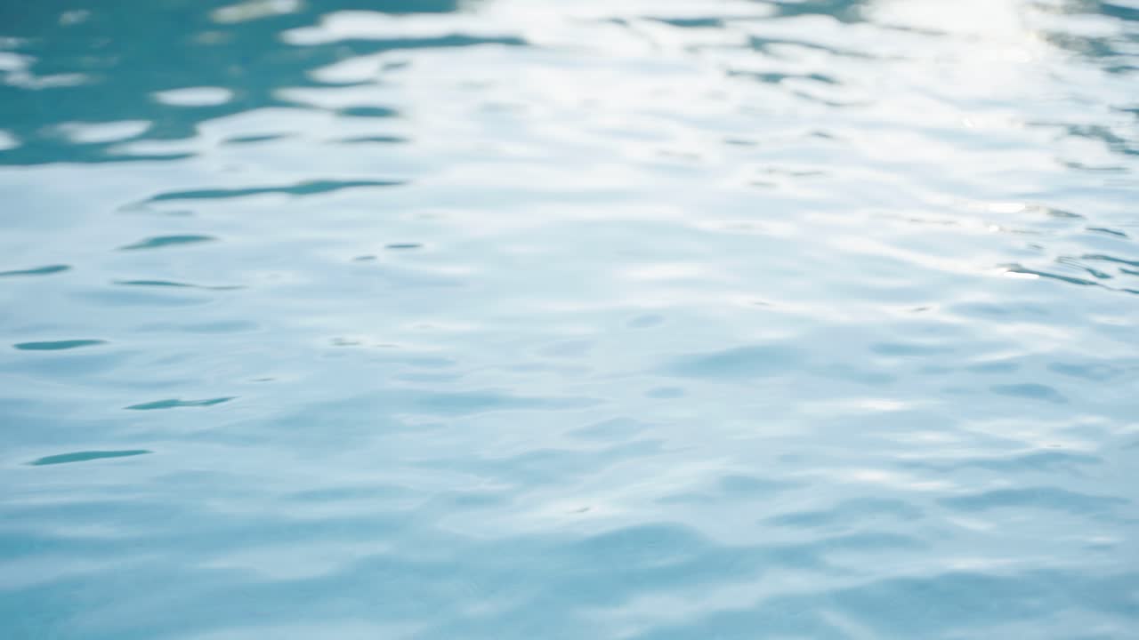 Tranquil water ripples shimmer across fiberglass pool in stylish outdoor setting