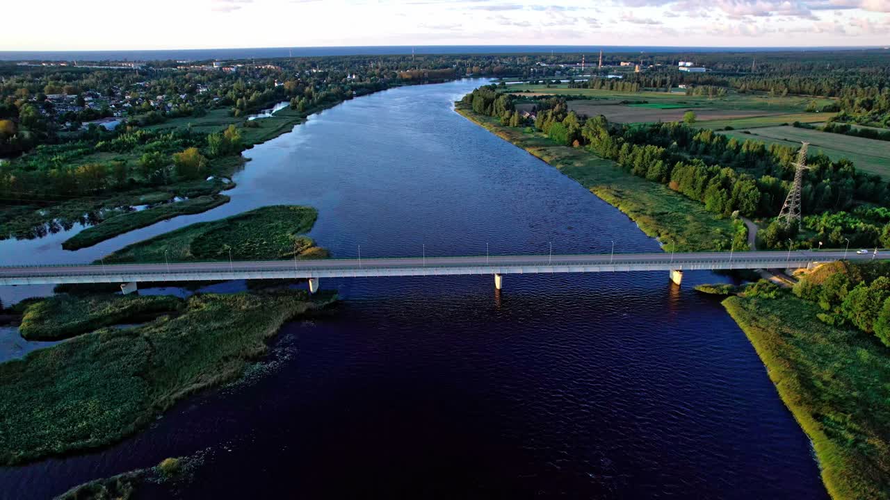 Stunning aerial view of river and bridge in Latvia during golden hour