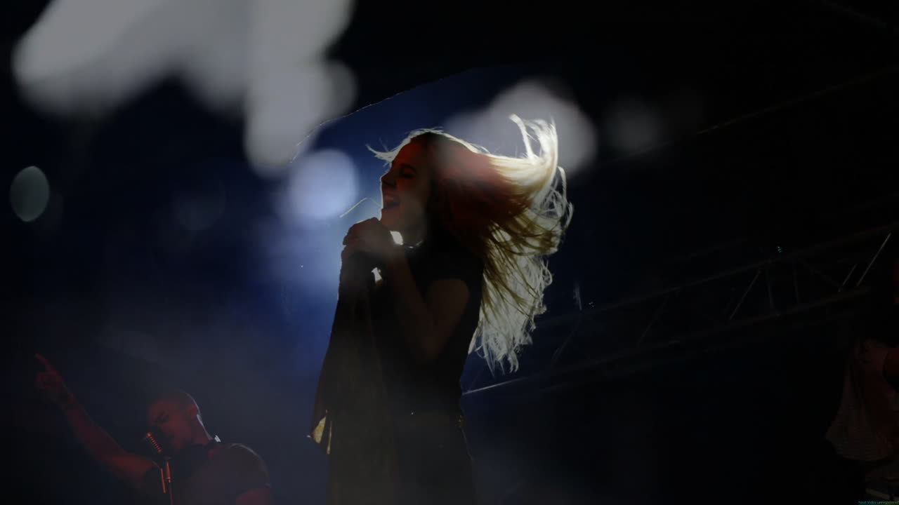 female singer and male musician performing on stage, with animated soundwave graphs for marketing