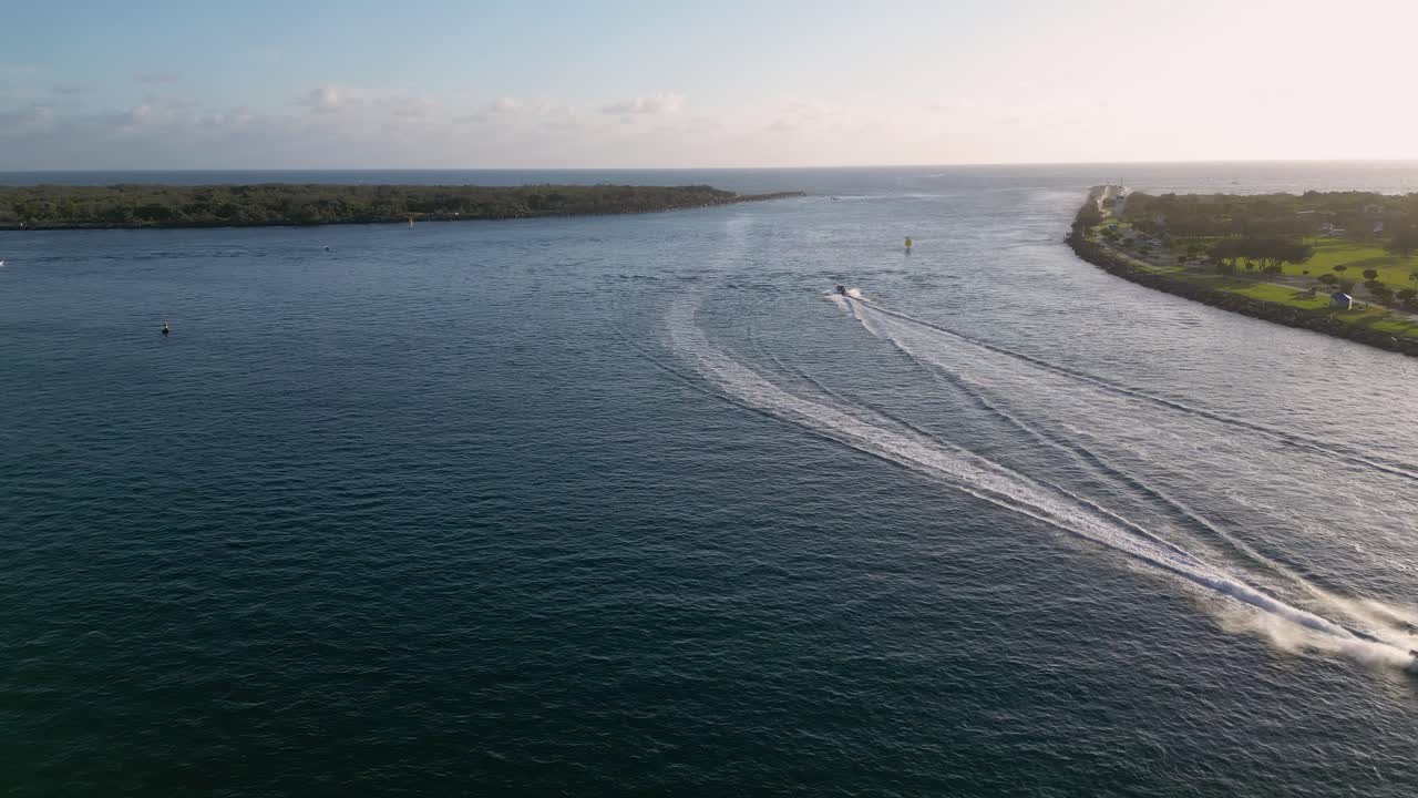 Aerial views over The Spit and seaway on the northern end of the Gold Coast in the morning on a sunny day.