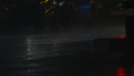heavy rain at night city and car traffic on wet road