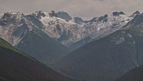 Rogers-Pass-BC-Canada-Aerial-v3-zoomed-flyover-capturing-spectacular-landscape-of-forested-valley,-mountain-range-summit-and-breathtaking-views-of-Youngs-peak---Shot-with-Mavic-3-Pro-Cine---July-2023