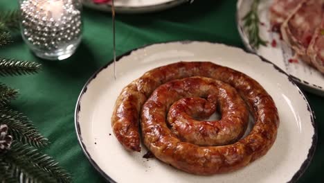 spiral sausage being cut on a plate