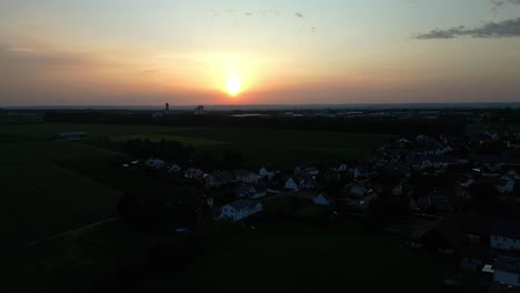 sunrise in europe as light breaks across the sky illuminating village