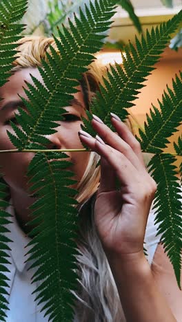 woman hiding behind ferns