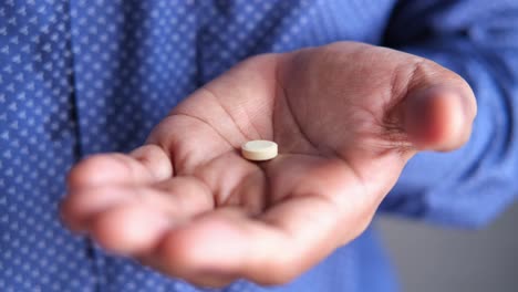 person holding a pill