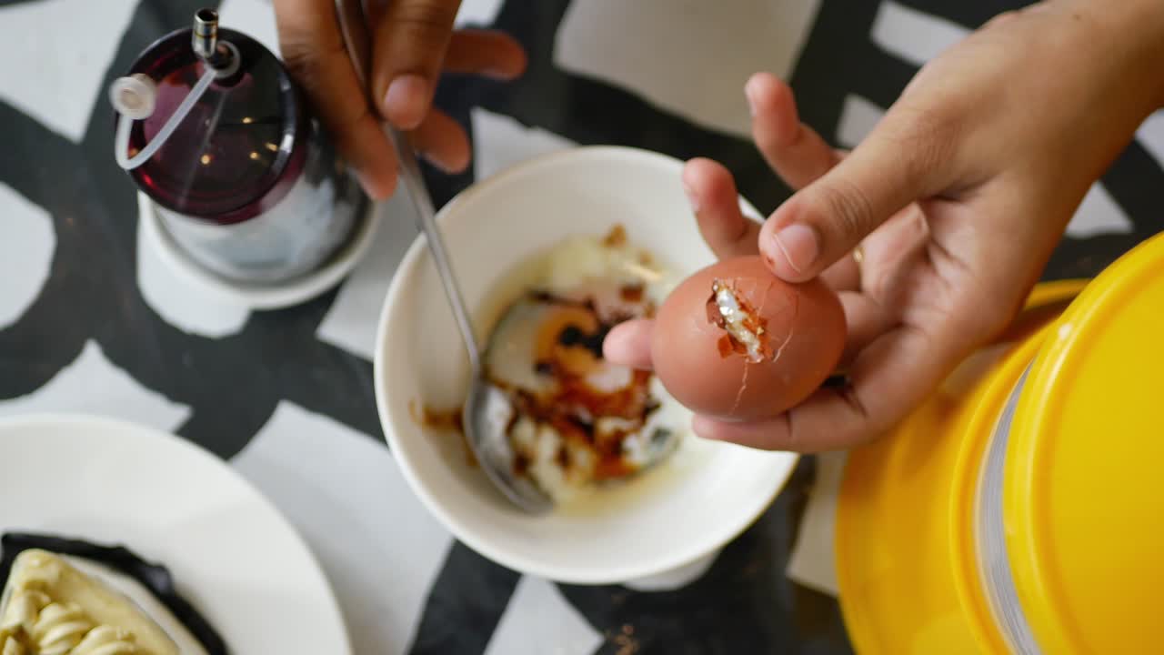 Top view of crack a egg with a spoon