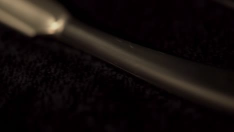 close-up of a safety razor on a black towel