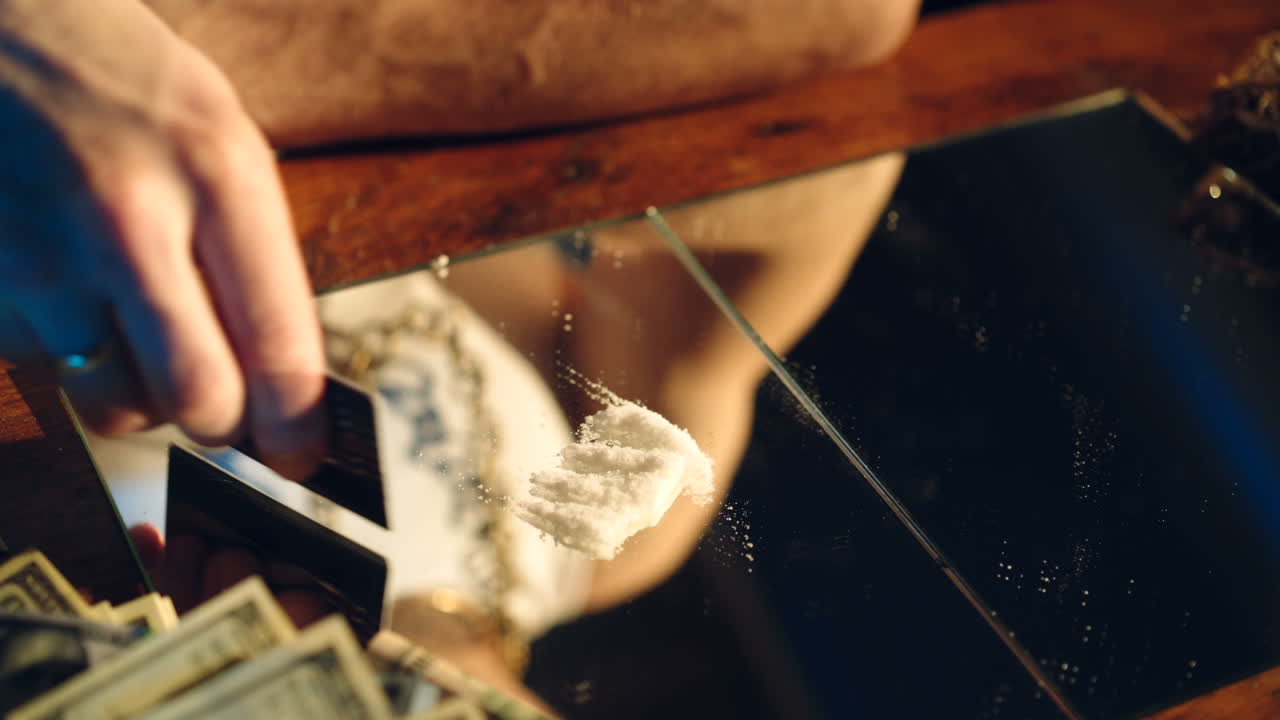 Drug addict preparing cocaine lines. Cocaine powder sorted. Concept of drug abuse. Social problems