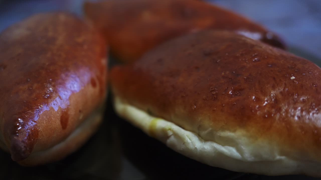 Warm, freshly baked rolls showcase a golden-brown crust and soft interior. Perfect for food-related projects needing a comforting, appetizing feel