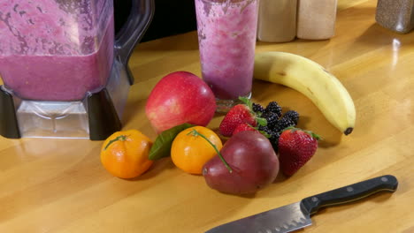 placing glass of fruit smoothie down after drinking