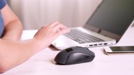 a woman works on a laptop while sitting at home