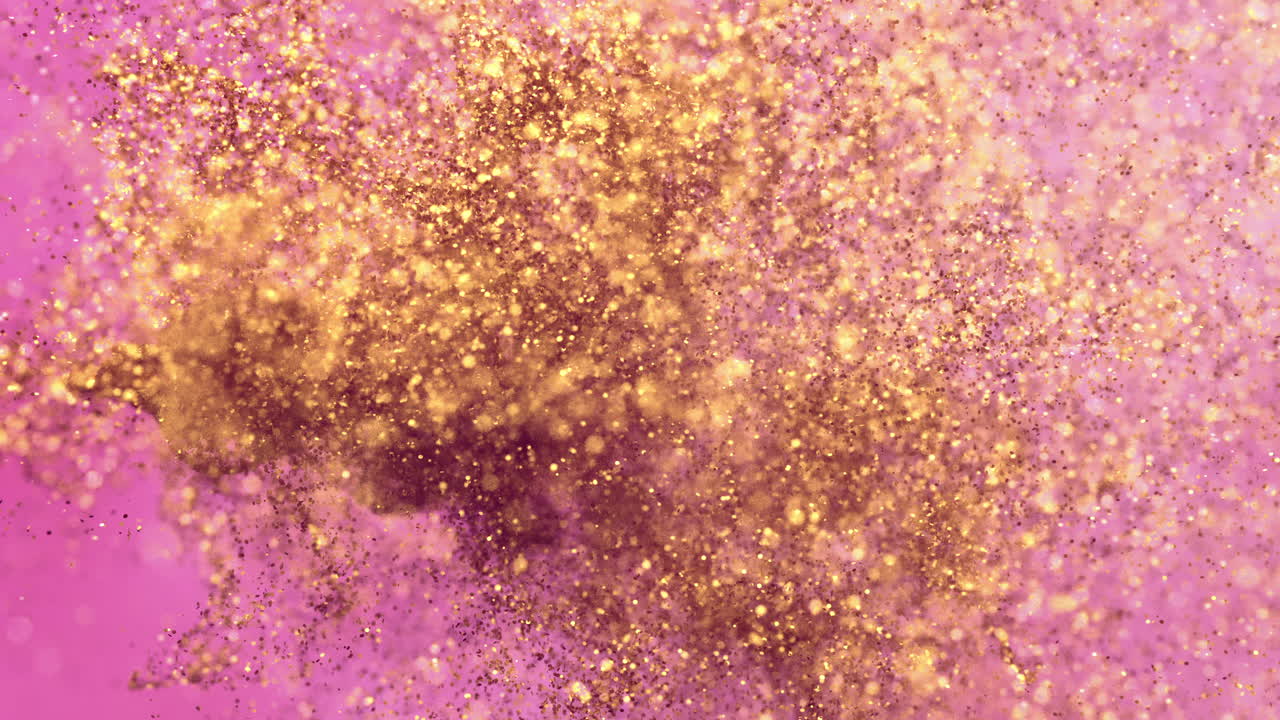 Particelle di glitter dorato che si dissolvono su sfondo rosa