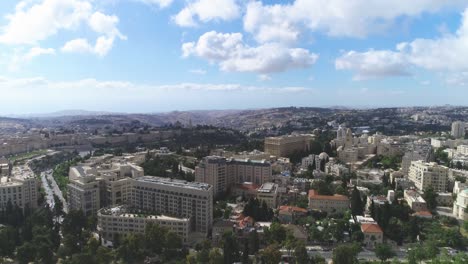 aerial fly over jerusalem with villages and settlements view. showing the wonder of co-existing living in cityscape with famous landmark against blue sky