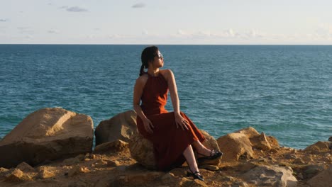 slow motion, young woman seated, con dao island secluded beach retreat