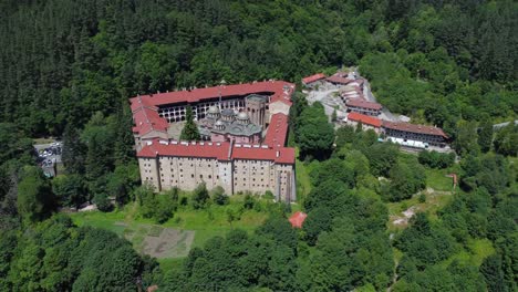 cinematic drone footage circling above rila monastery on sunny day - bulgaria