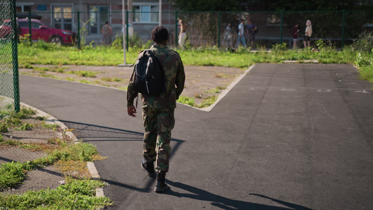 Soldier Contemplates Choice At Sunny Intersection Amid Neighborhood Surroundings, Military Personnel Evaluates Options At Bright Junction Within Suburban Environment During Reflective Moment