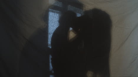 silhouettes of couple kissing