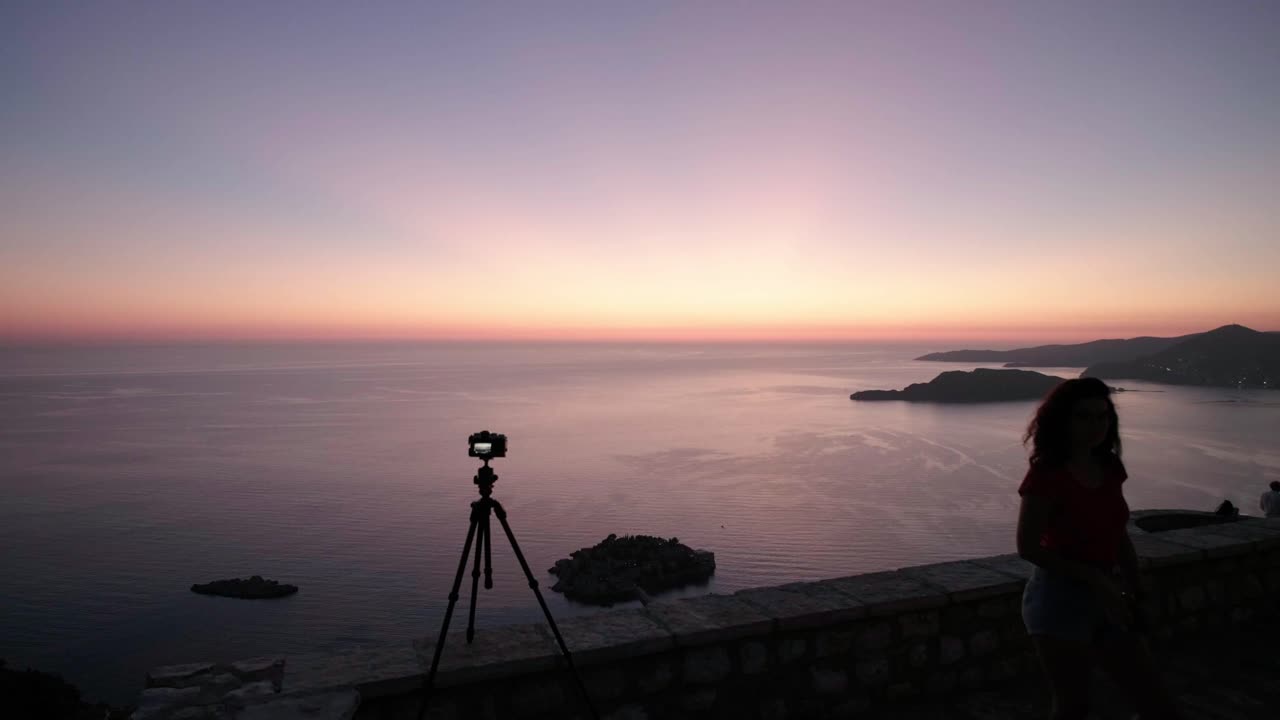 Sunset overlooking the coastline in Montenegro near Sveti Stefan. Camera taking a photo of the sunset over sveti stefan