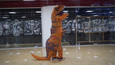 person in a t-rex costume in a shopping mall