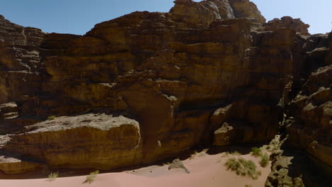 peak through rocky canyons in wadi rum desert in jordan - aerial shot