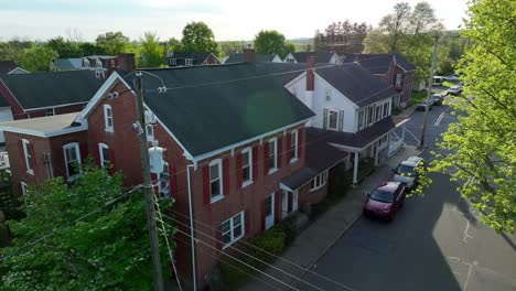 a slow cinematic shot over a colonial style house on a street in america