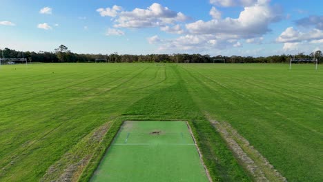aerial view of a sports field with a cricket pitch, captured by drone under clear skies on the gold coast