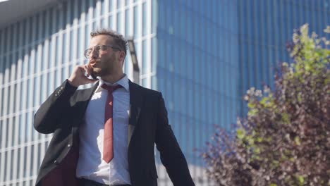 frustrated and nervous businessman talking on the phone.