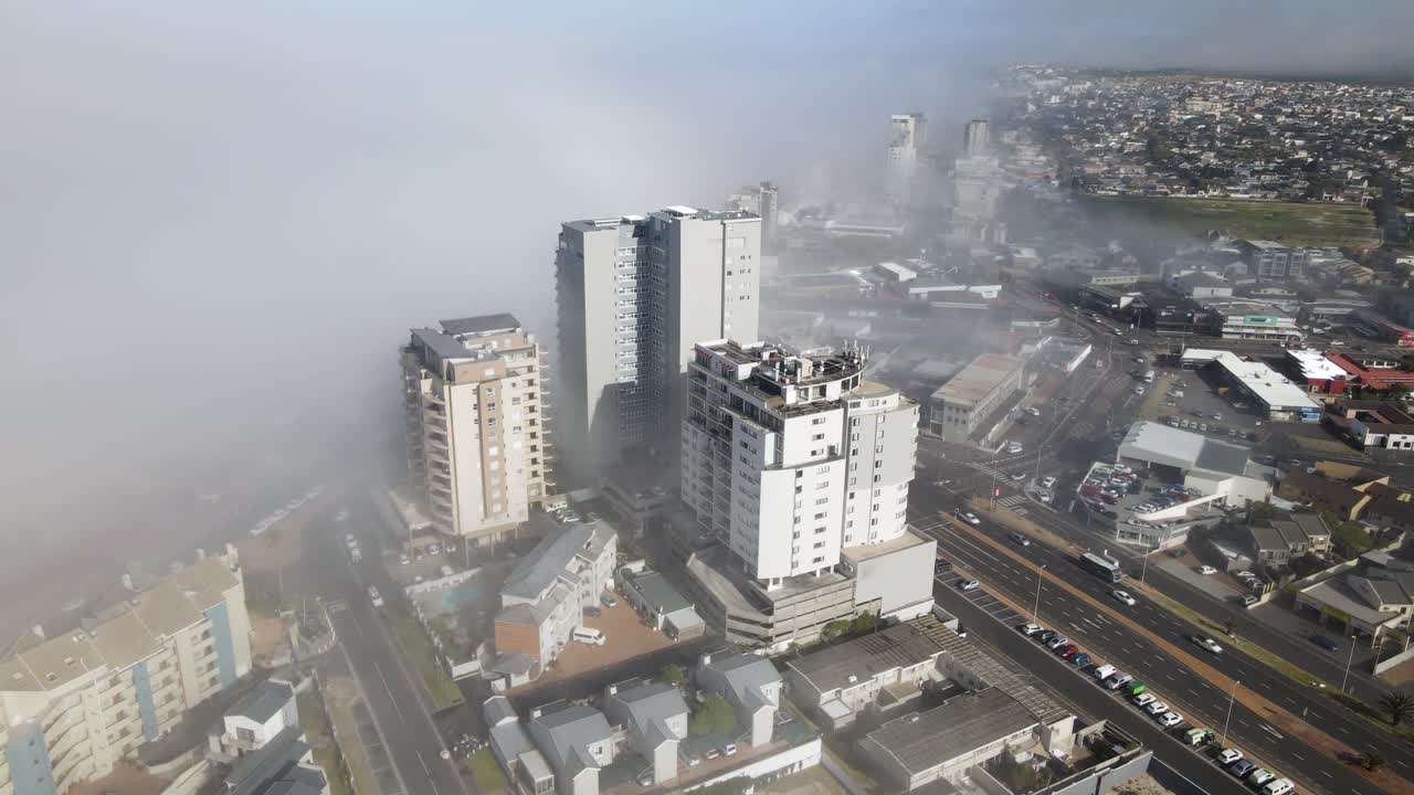 los edificios del centro de bloubergstrand bloquean la niebla entrante del océano con el tráfico matutino en las calles