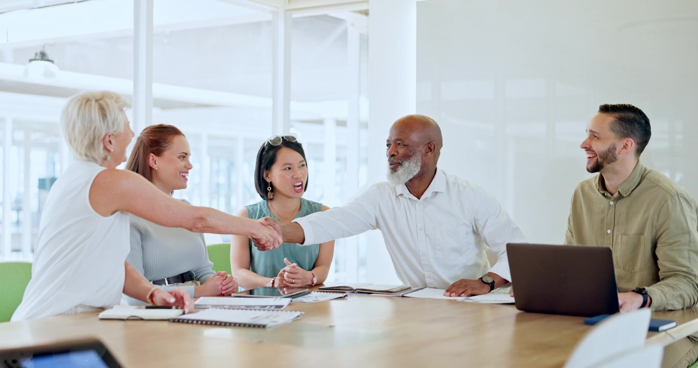 Diverse Business Team Shaking Hands During Office Meeting