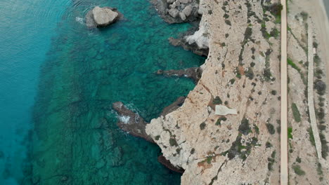 Rocky-coast-of-Ayia-Napa-and-Bridge-of-Lovers-in-aerial-downwards-view