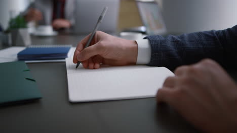 entrepreneur hands writing paper document in office. business meeting concept.