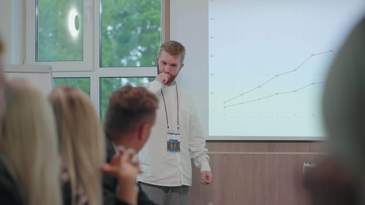 confident business coach is speaking in educational seminar in big company conference of marketing