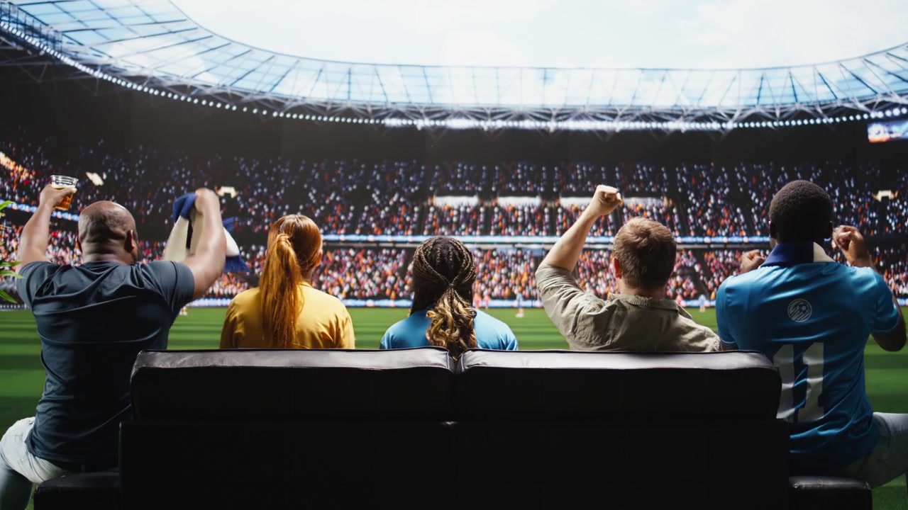 Football fans celebrate goal, immersive broadcast creating stadium experience