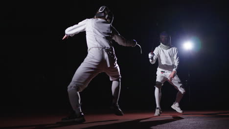 two fencers competing in a match.